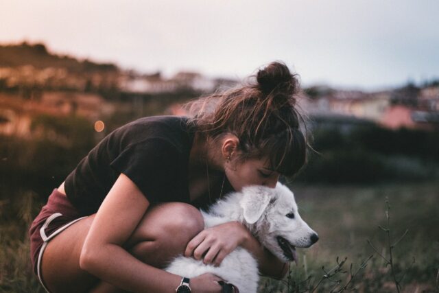 dog kiss and hug by woman